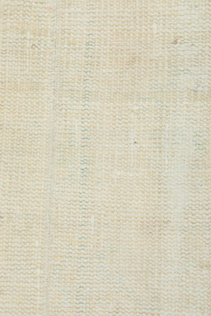 View of the back of the rug, showcasing the hand-knotted wool on cotton foundation.