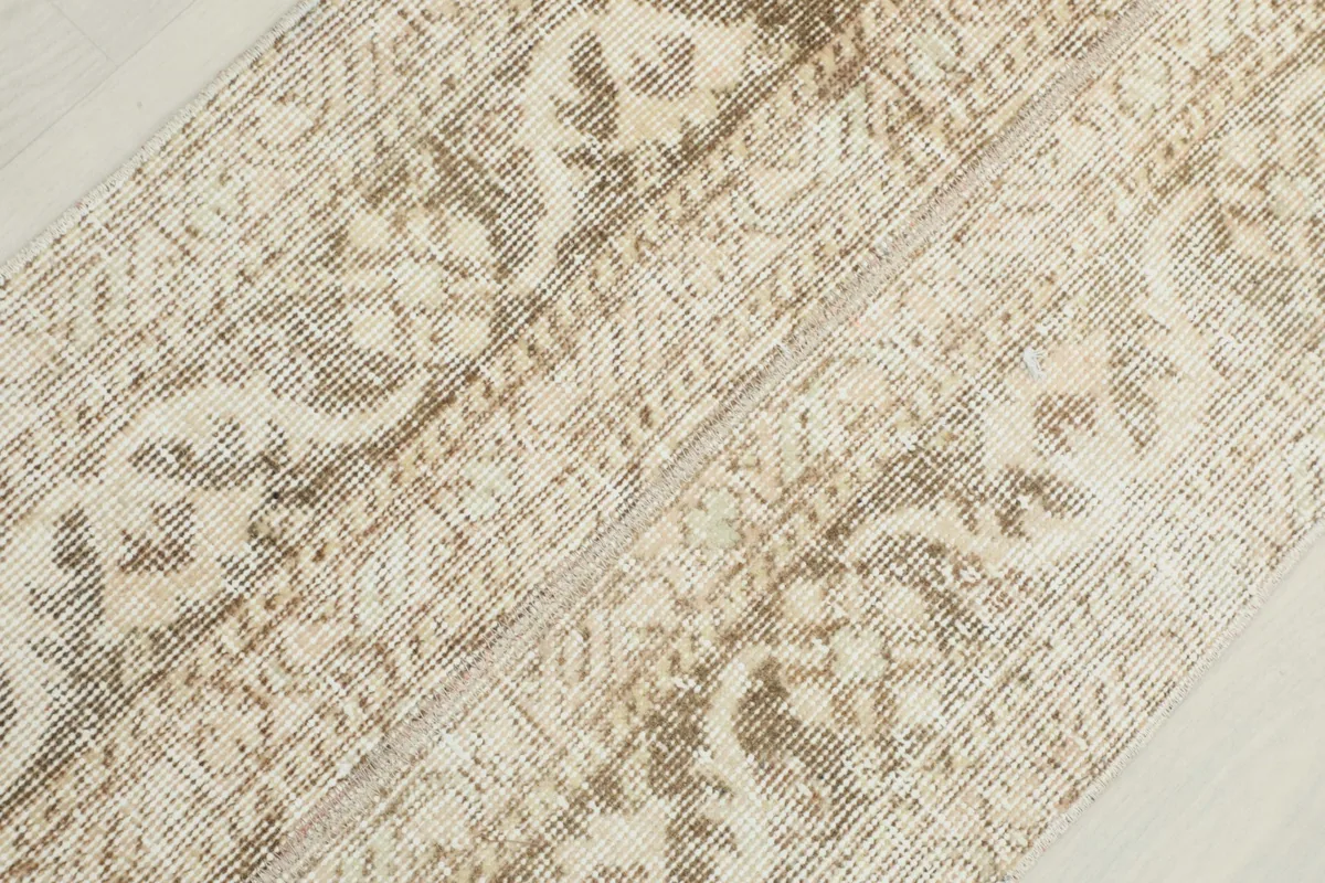 Detailed view of the hand-knotted wool pile and subtle color variations