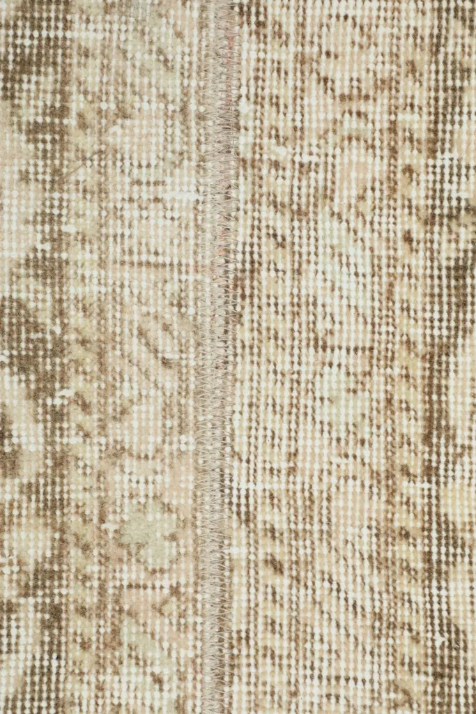 Close-up of the low wool pile, showing the individual knots and distressed areas