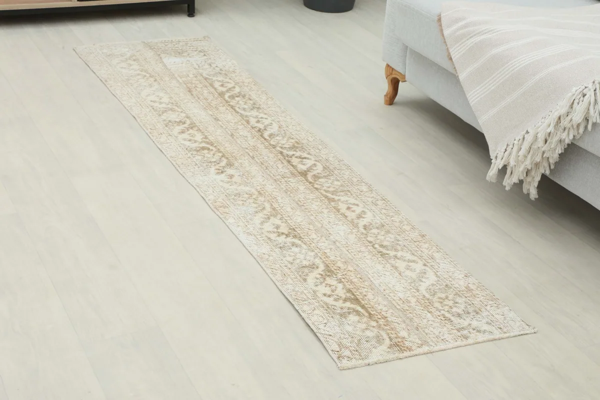 Overhead view of the beige runner rug showcasing its full length and pattern