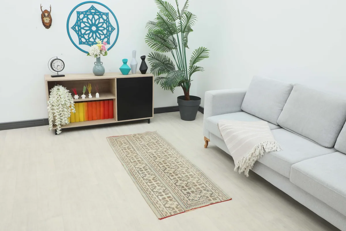 Vintage runner rug displayed in a modern living room setting, showing its scale and aesthetic
