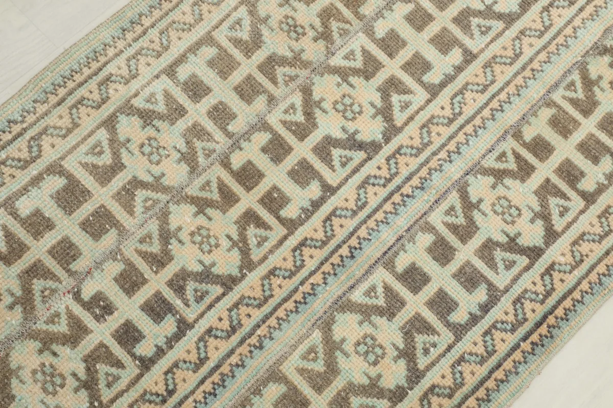 Close-up of the low wool pile and intricate hand-knotted details of the runner rug