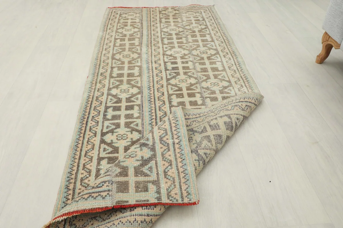 Partial fold of the rug, showing the flexibility and thickness of the vintage piece