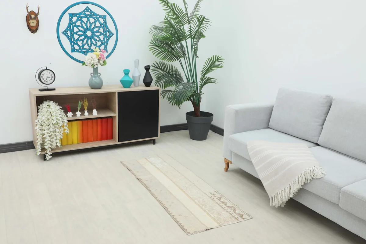 Vintage Anatolian runner rug placed in a modern living room setting, showcasing its scale and color.
