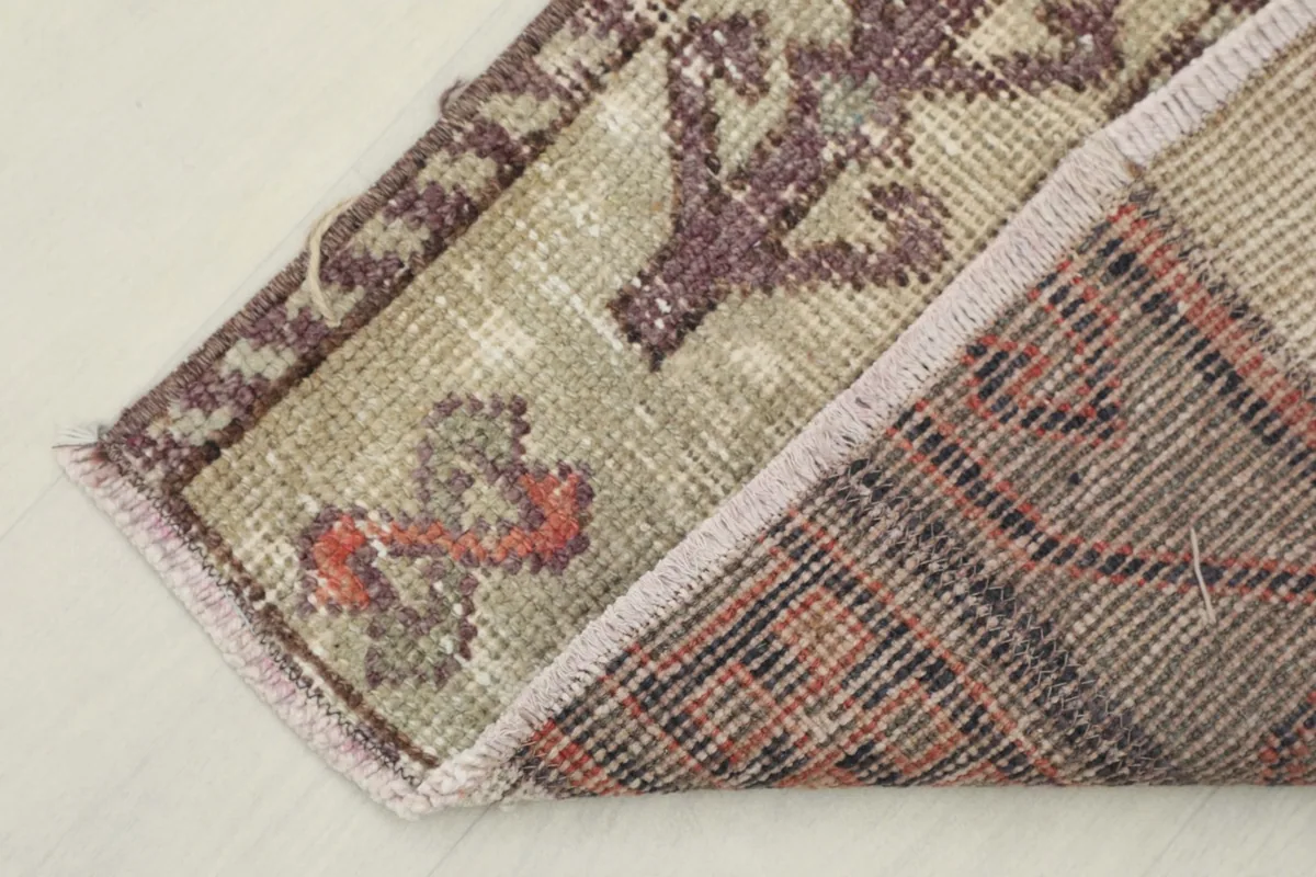View of the back of the rug, confirming its hand-knotted construction and cotton foundation