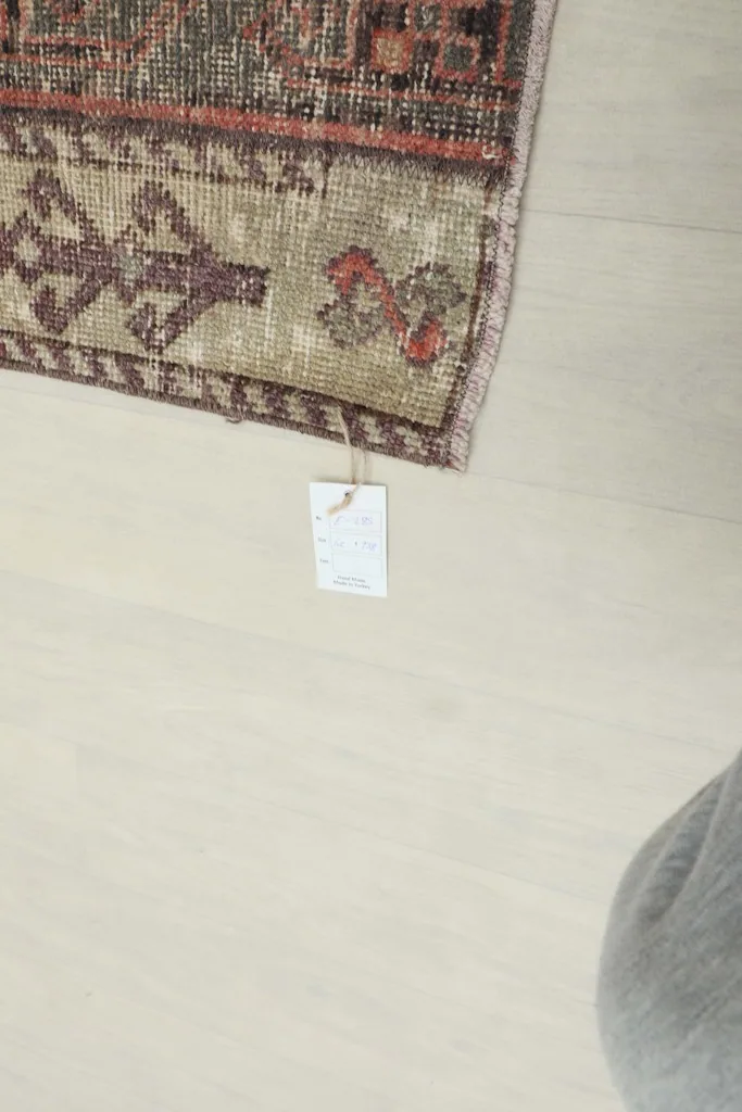 Close-up of the rug's corner with the product tag attached