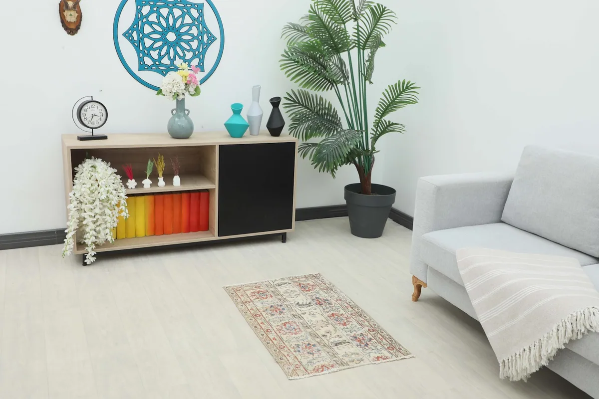 Vintage Anatolian rug displayed in a living room setting, showing its size relative to furniture.