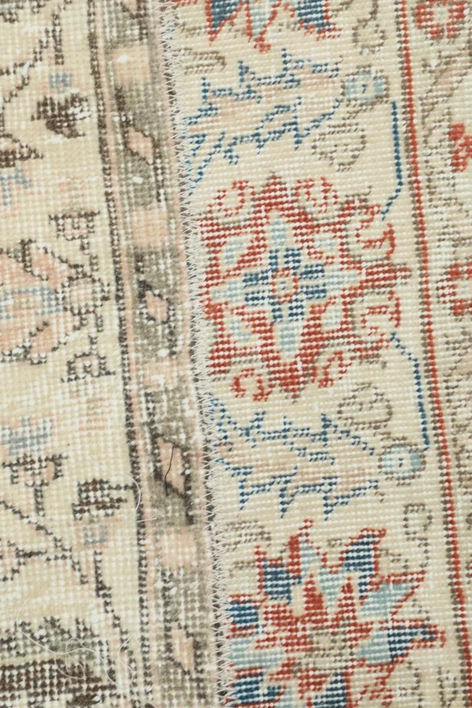 Macro detail of the knotting and color variations within the red and blue motifs.