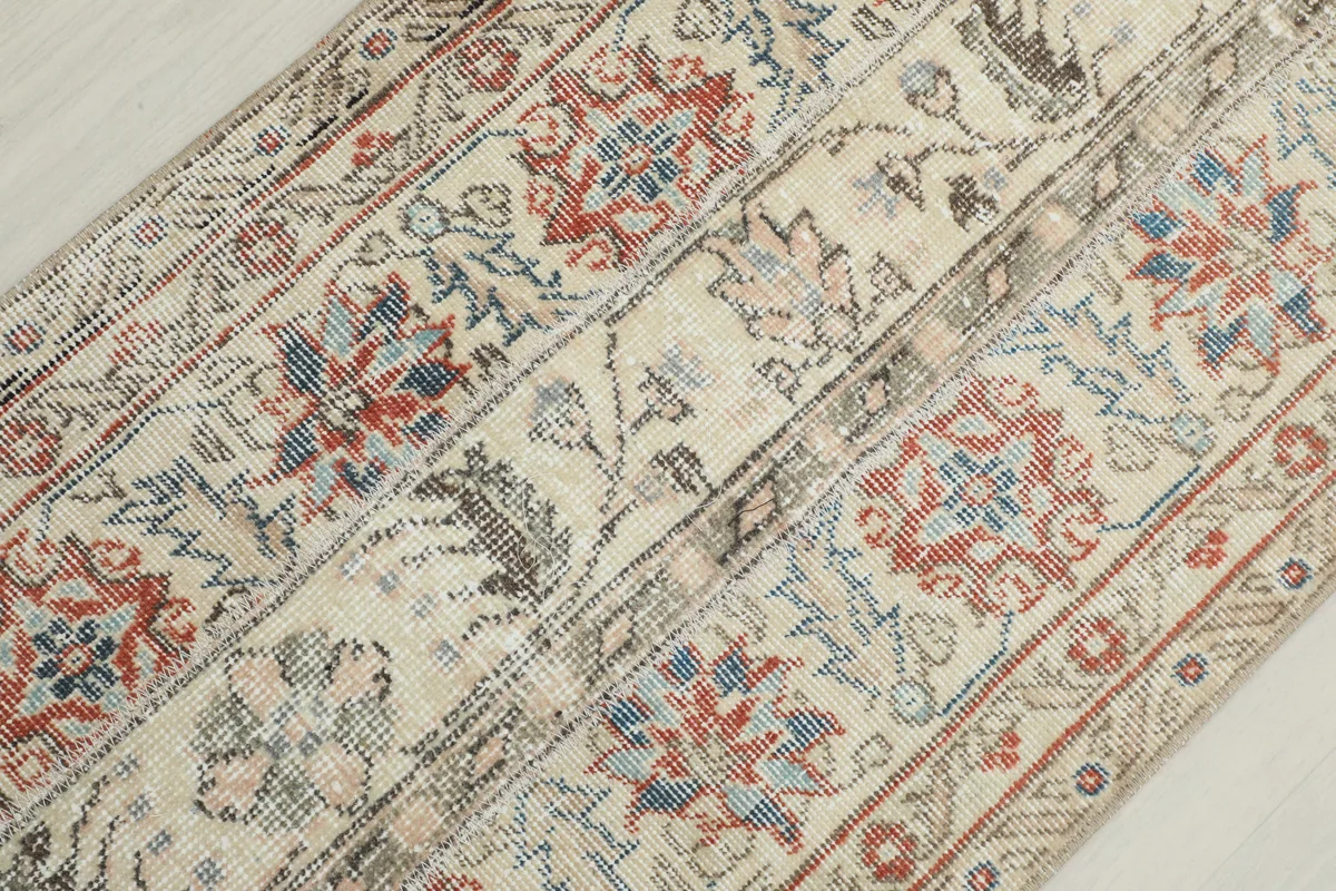 Close-up of the rug's low wool pile and the intricate hand-knotted texture.
