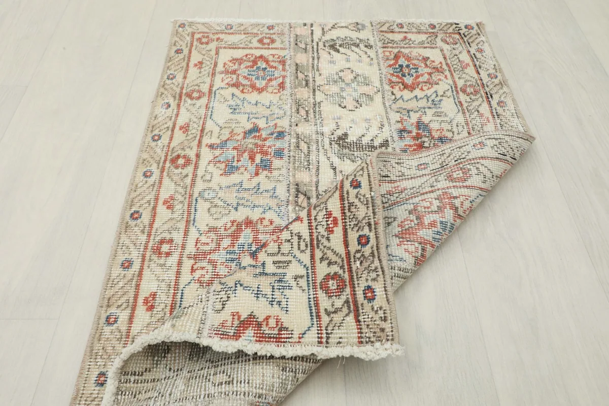 Rug partially folded, showing the flexibility and the overall construction from an angle.