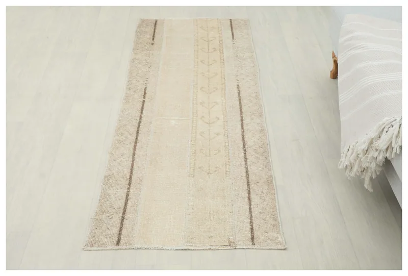Full top view of the 2'0" x 5'5" cream and beige vintage runner rug on a white background.