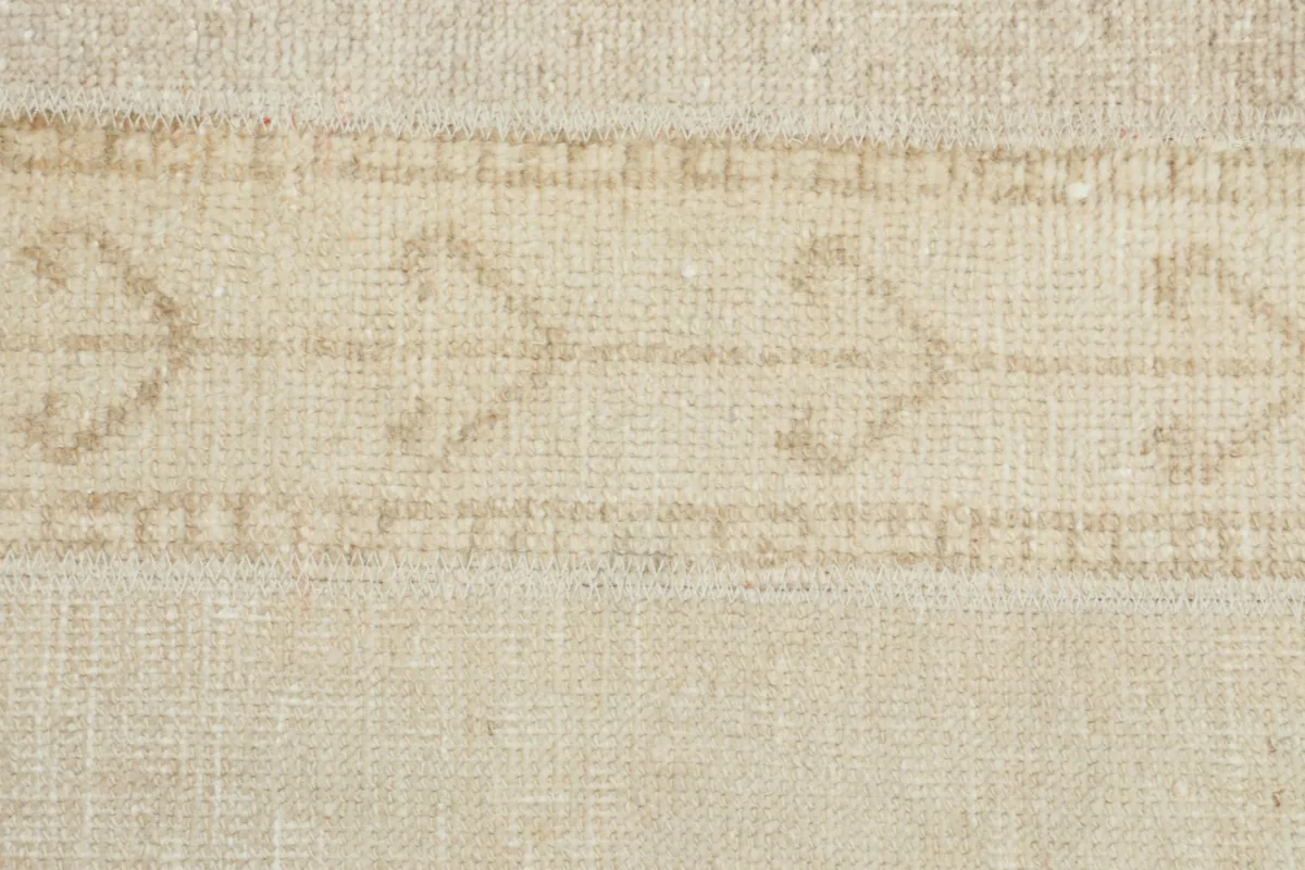 Extreme close-up view of the low wool pile, showing the texture and hand-knotted construction.