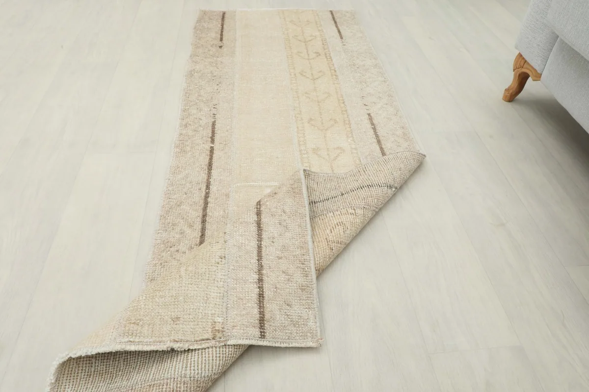 Angled view of the runner rug with a corner folded back, displaying the thickness and construction.