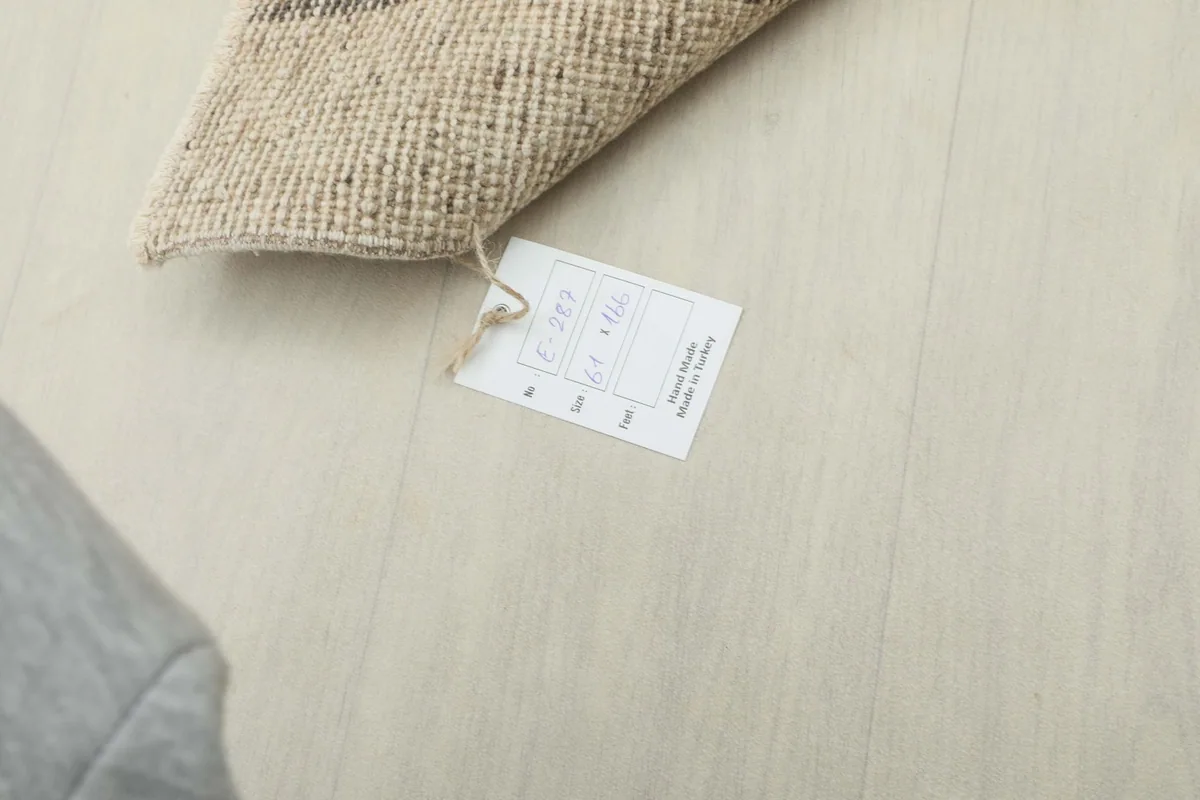 Close-up of the product tag, showing the rug's dimensions and origin details.