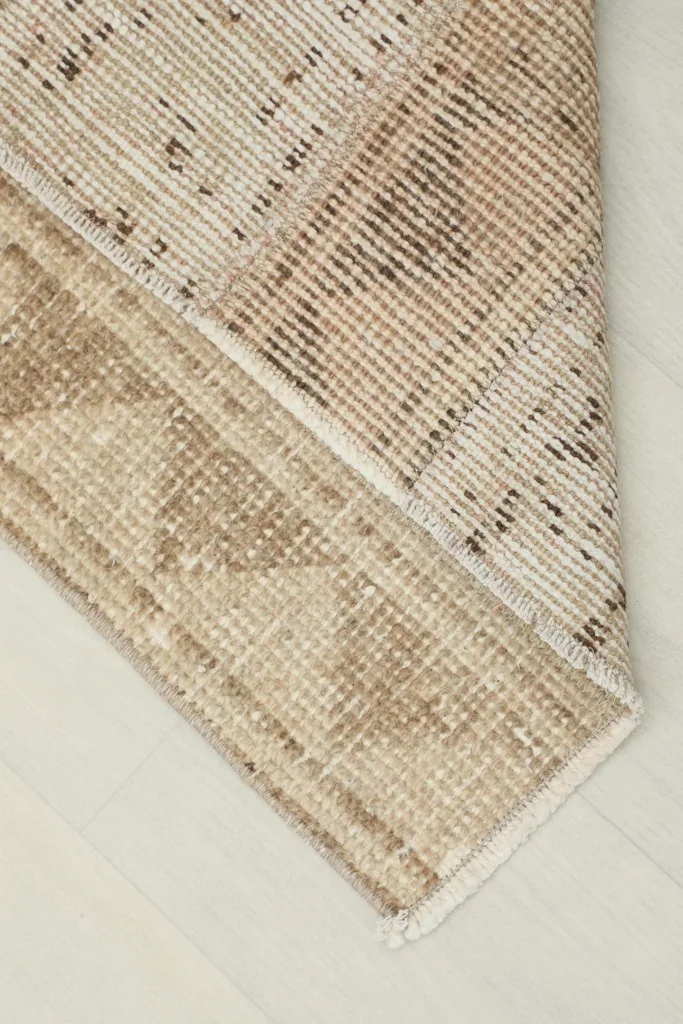 View of the back of the runner, revealing the cotton foundation and knotting