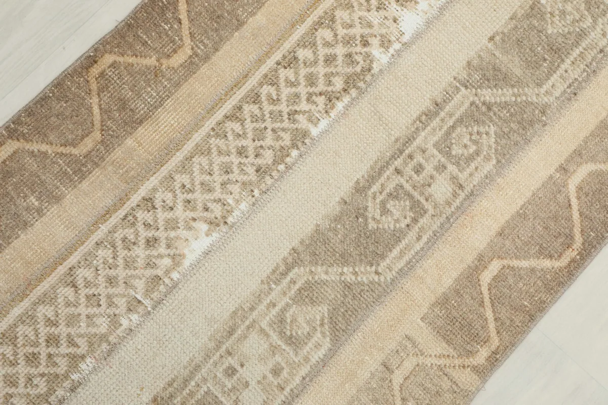 Diagonal close-up of the rug's patterns, emphasizing the intricate tribal designs.