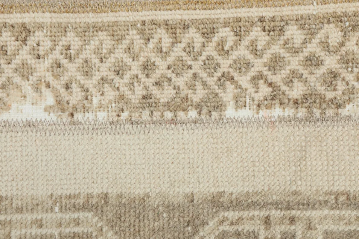 Close-up of the low pile and weave structure, showing the wool fibers and cotton foundation.