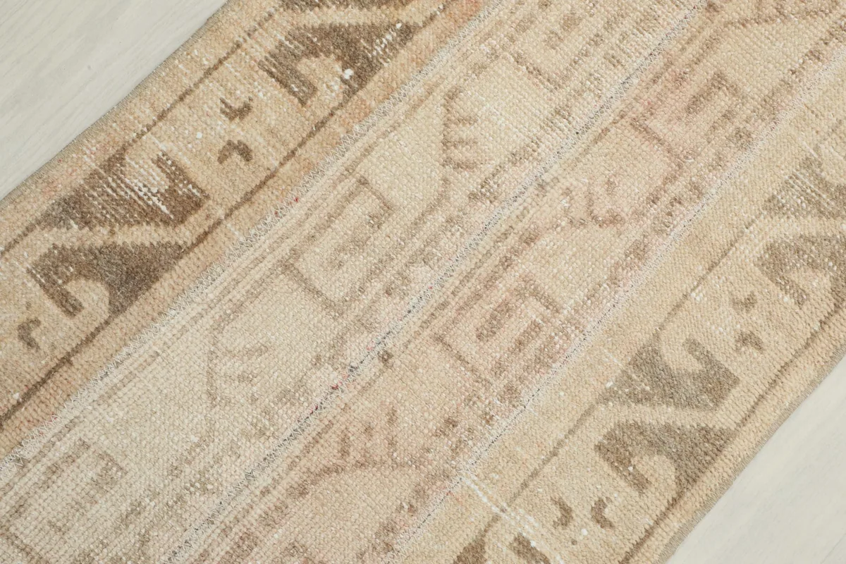 Close-up of the central field and border patterns, showing the hand-knotted texture.