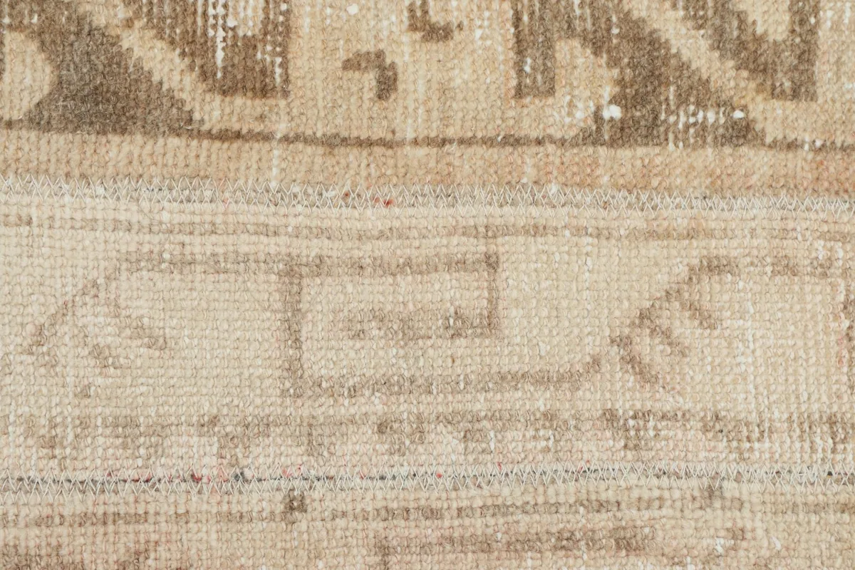 Extreme close-up of the low pile and intricate geometric design elements.