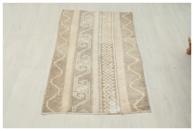 Full top view of the beige and brown tribal striped vintage Anatolian rug