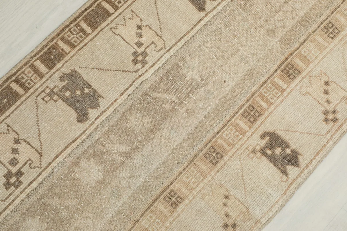 Overhead detail view of the rug, focusing on the central striped pattern and worn texture.