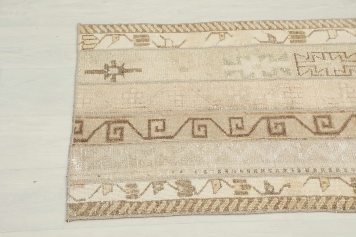 Close-up of the runner rug's opposite end, highlighting the hand-knotted texture and tribal motifs.