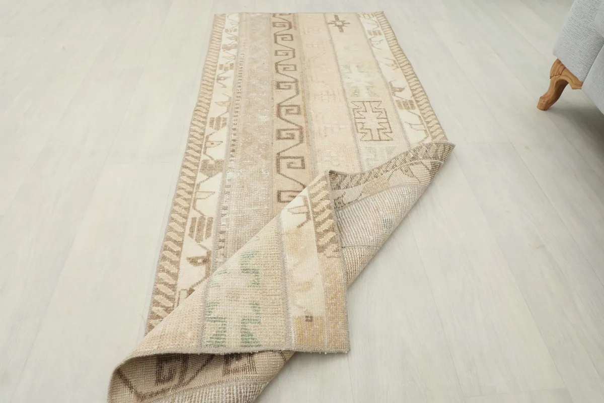Rug partially folded, displaying both the top surface with patterns and the reverse side.
