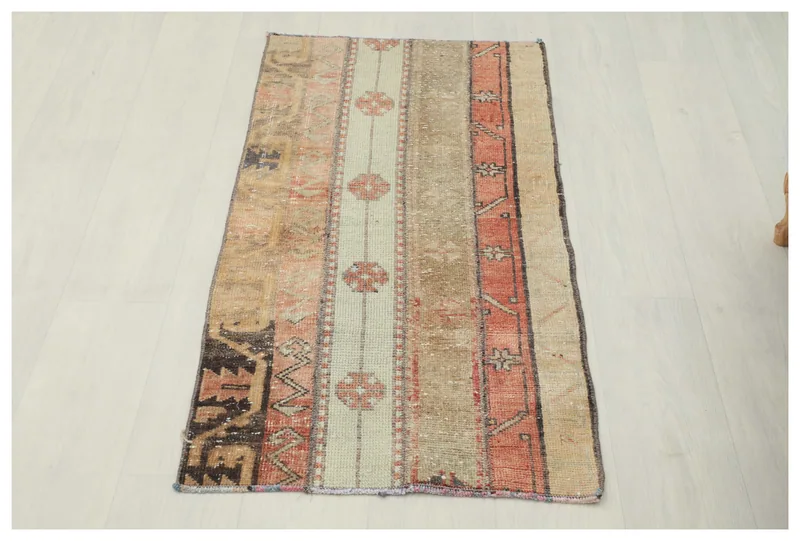 Full top view of the 1'10" x 4'0" beige and rust striped vintage Anatolian rug on a white background.