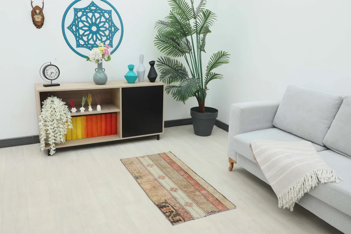 Vintage Anatolian rug displayed in a living room setting, showing its size in relation to furniture.