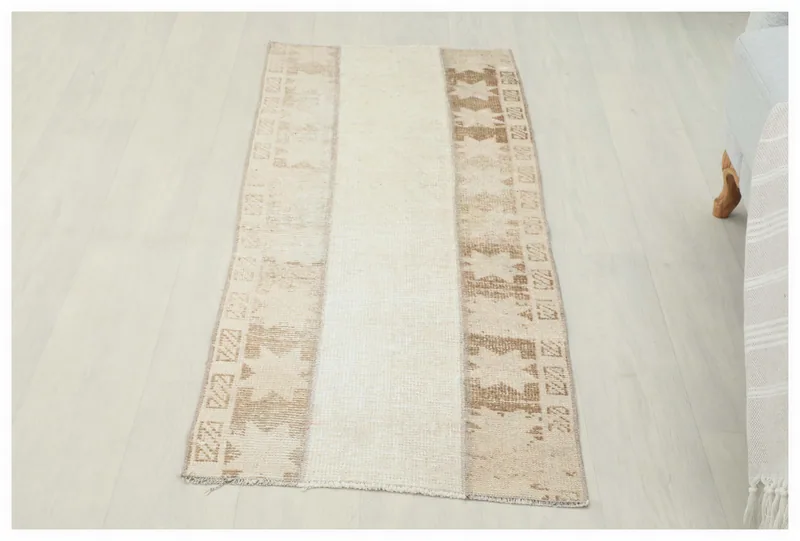 Full overhead view of the beige and tan geometric Anatolian runner rug on a white background.