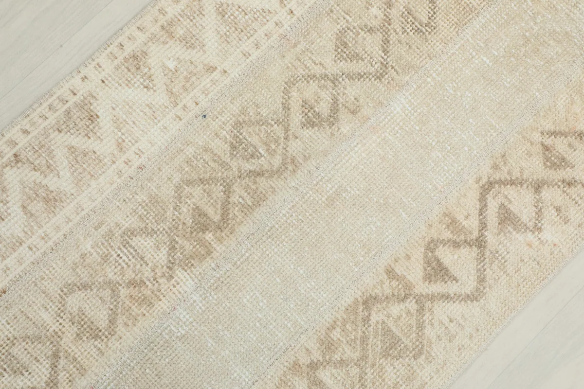 Overhead close-up showing the varied geometric patterns and texture of the wool pile.