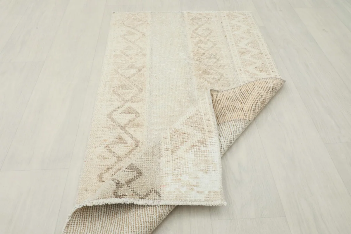 The rug partially folded, demonstrating its flexibility and the texture of the back.