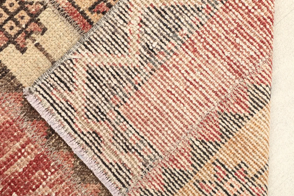 Close-up showing the low wool pile and the hand-knotted construction of the vintage rug.