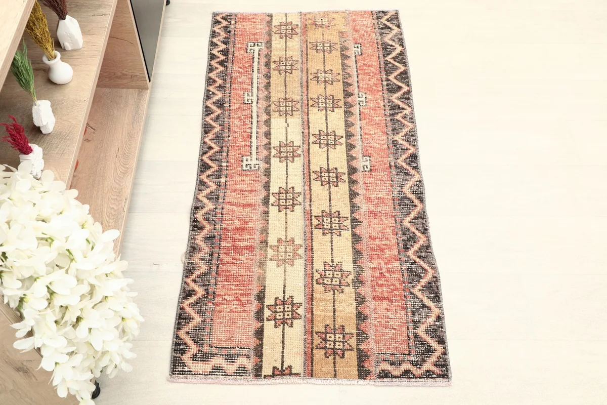 Overhead view showcasing the full length of the hand-knotted rust and beige striped rug.