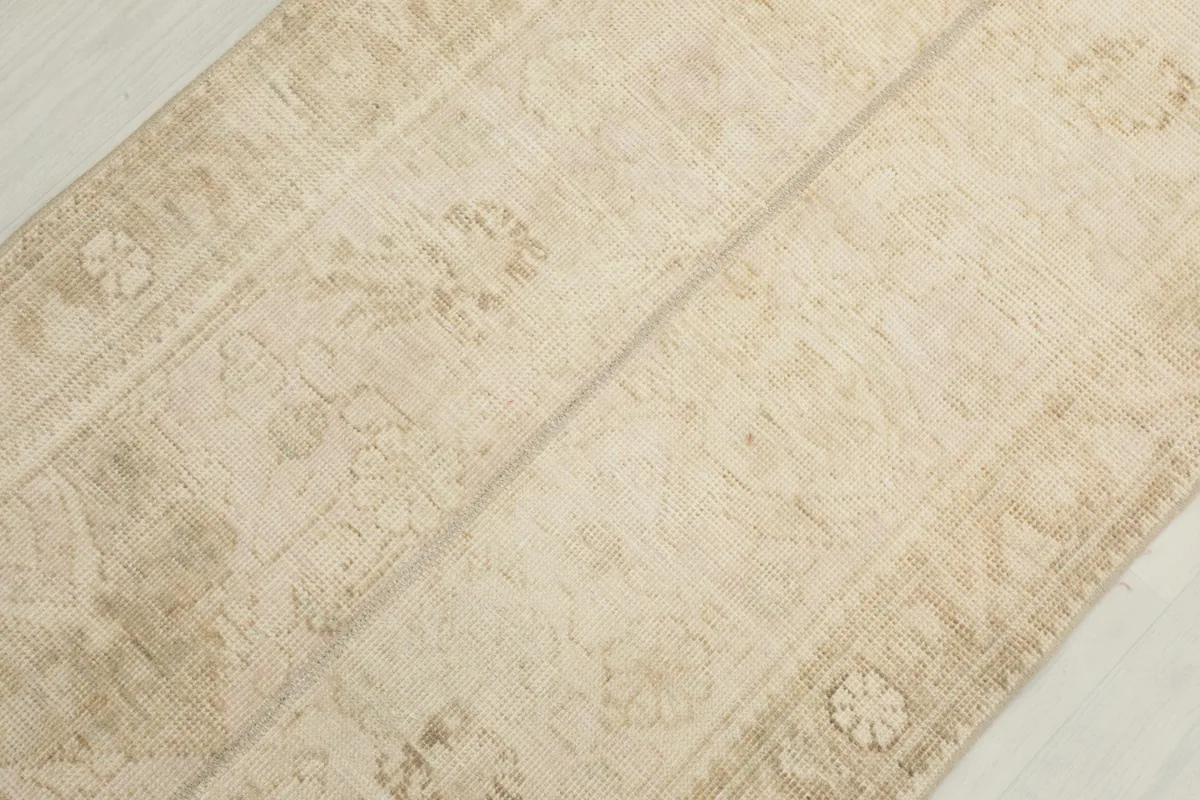 Detailed view of the rug's center, showing the transition of patterns and color variations.