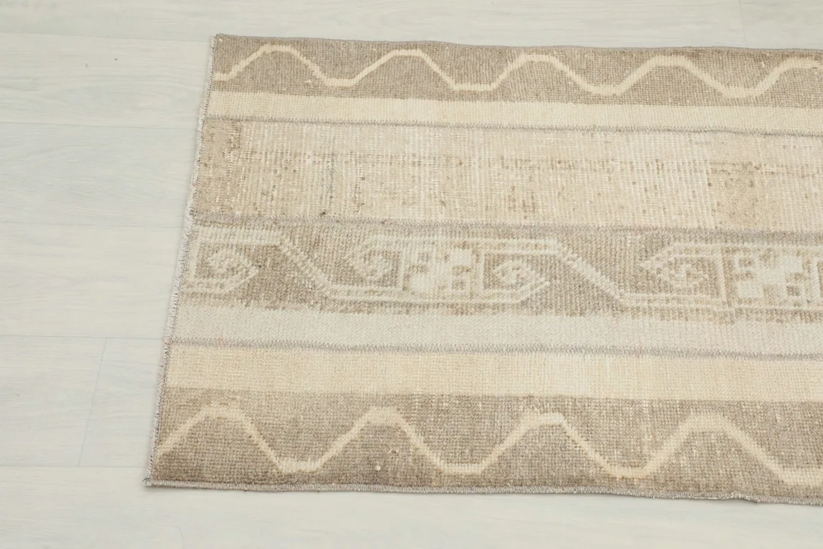 Detailed view of the patterned sections and textured wool pile of the vintage rug