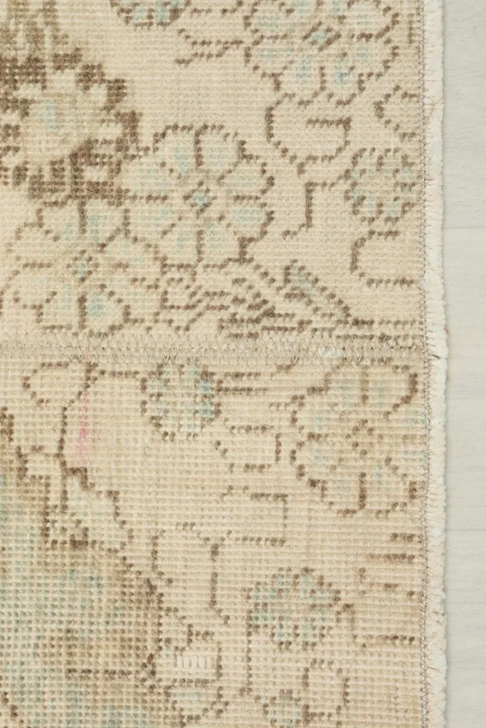 Close-up of the rug's edge, showing the short fringe and the tightly woven foundation.