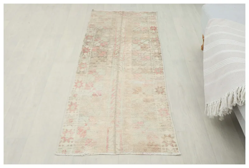 Full overhead view of the beige and rose vintage Anatolian runner rug