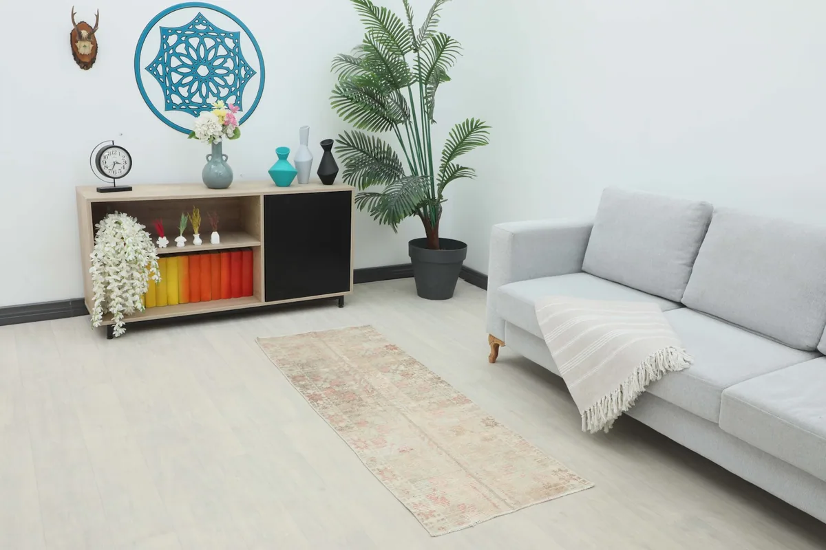 Vintage runner rug displayed in a living room setting with a sofa and console