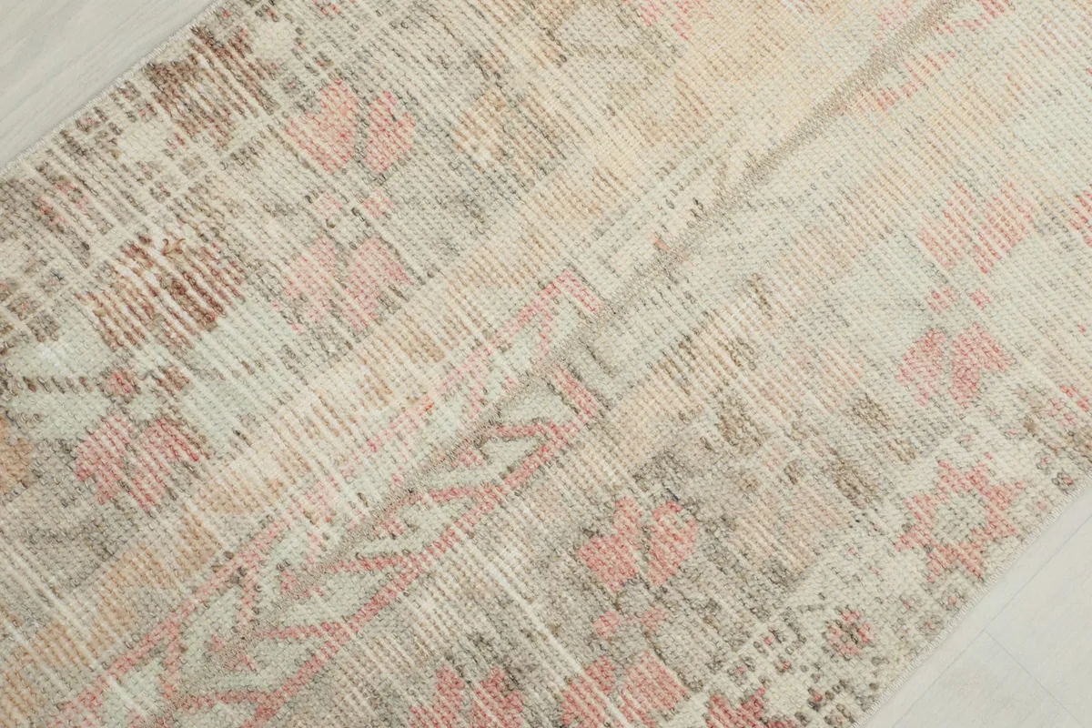 Close-up showing the low pile and intricate geometric motifs of the rug