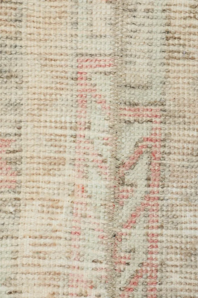 Very close view of the hand-knotted wool pile, showing its texture and wear
