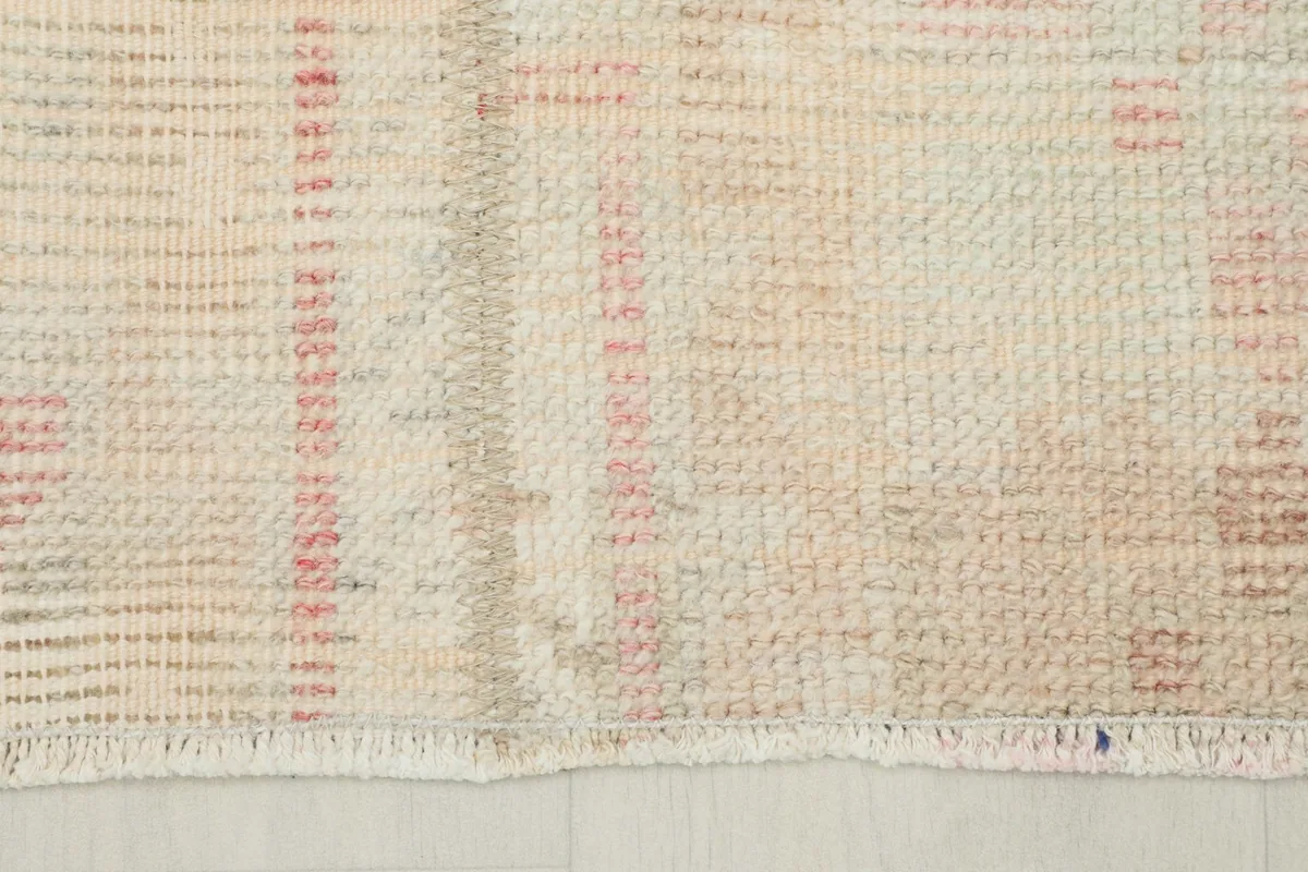 Detail of the rug's short, natural cotton fringe at one end