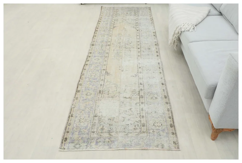 Full top view of the 2'11" x 10'0" faded beige and blue Anatolian runner rug.
