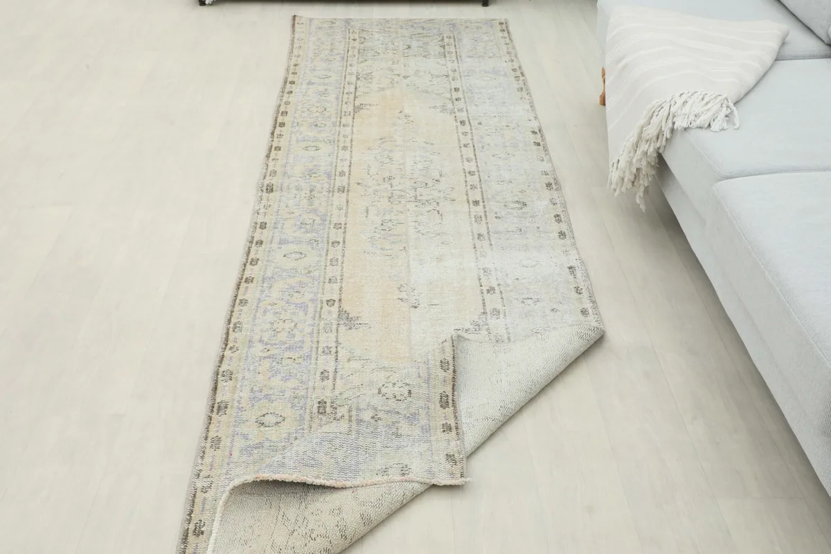Runner partially folded to illustrate the flexibility and thickness of the vintage wool rug.
