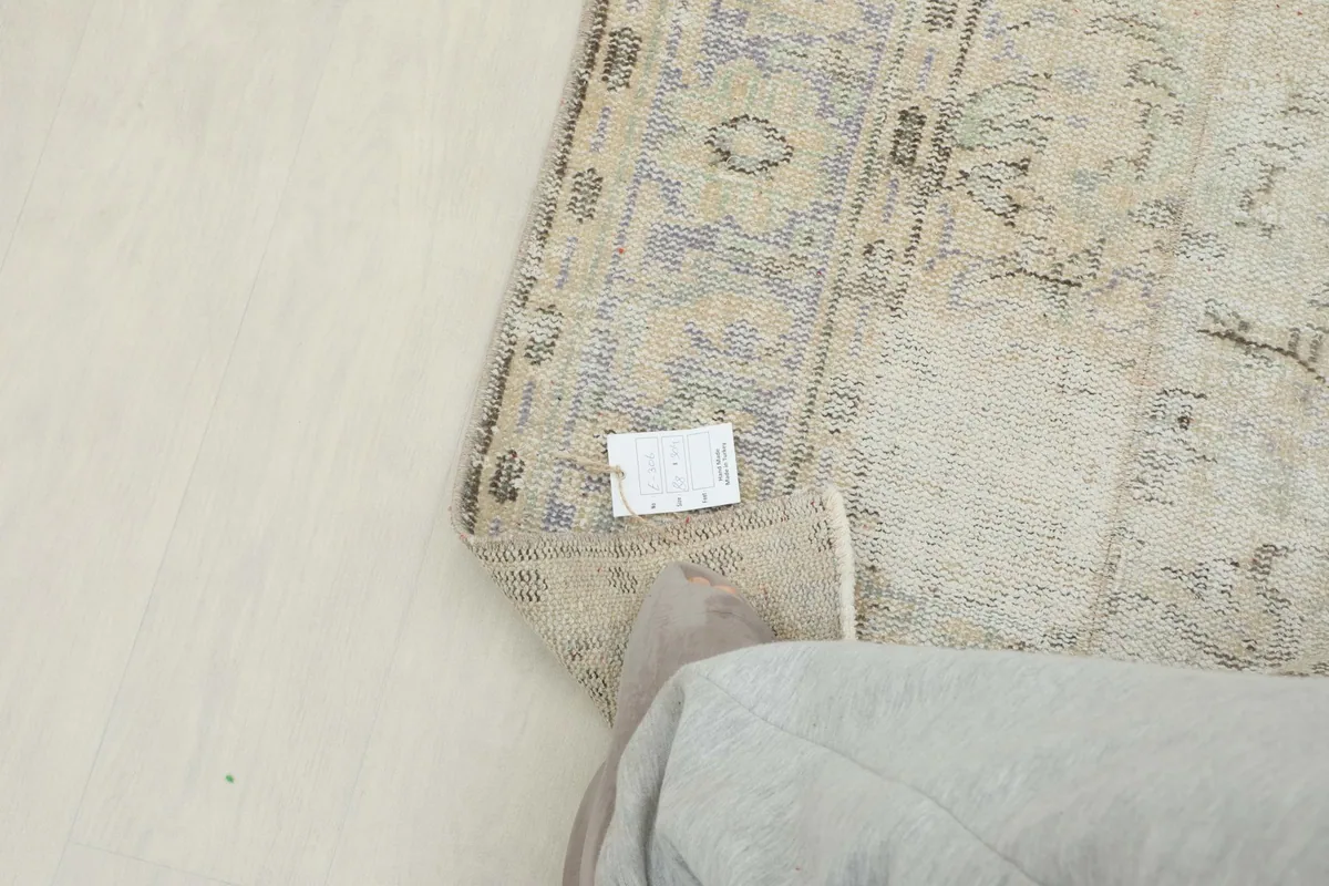 Corner of the runner with a tag, showing the reverse side and edge finishing.