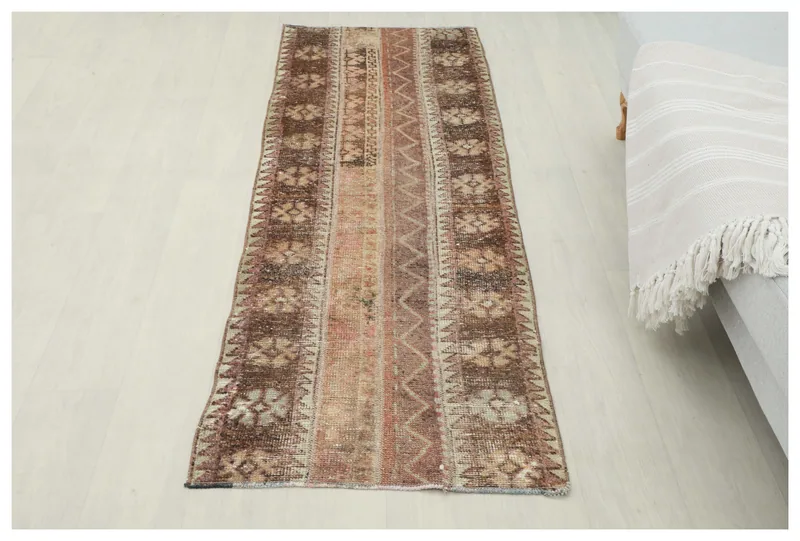 Full overhead view of the vintage brown and rose Anatolian rug