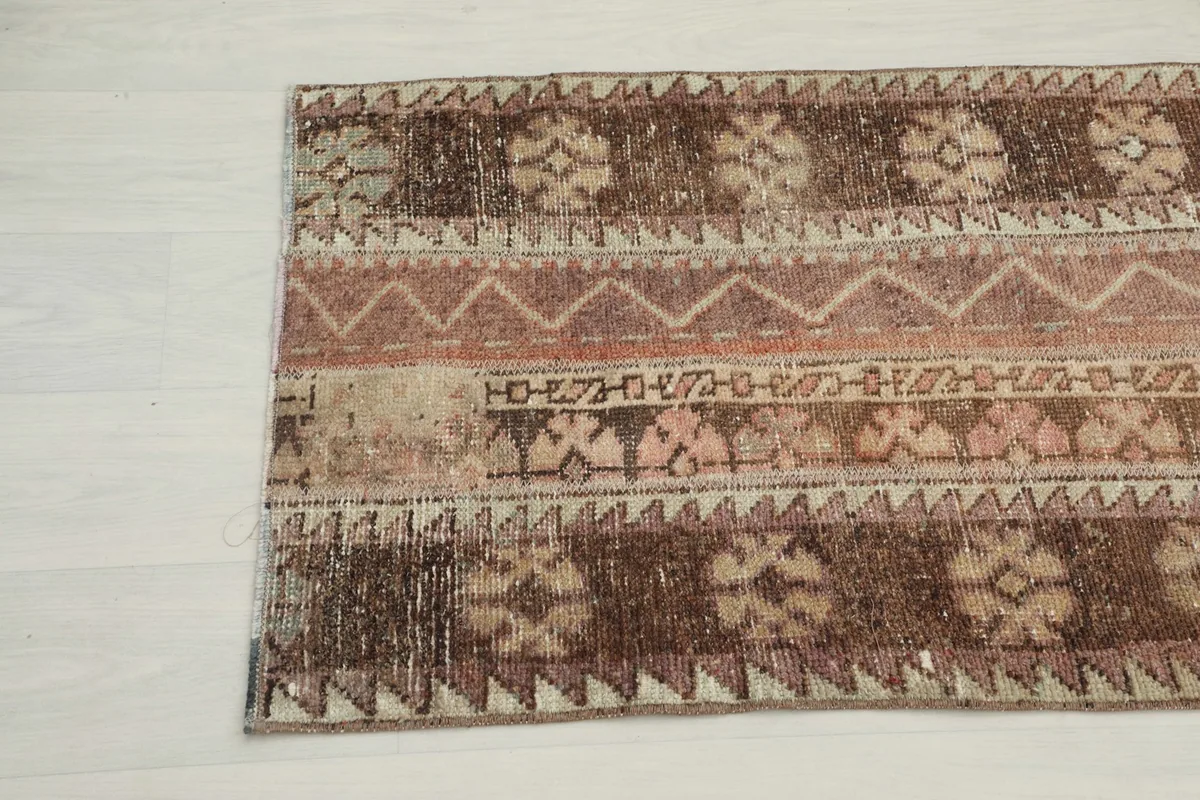 Close-up of the distressed texture and varied patterns on the rug's surface