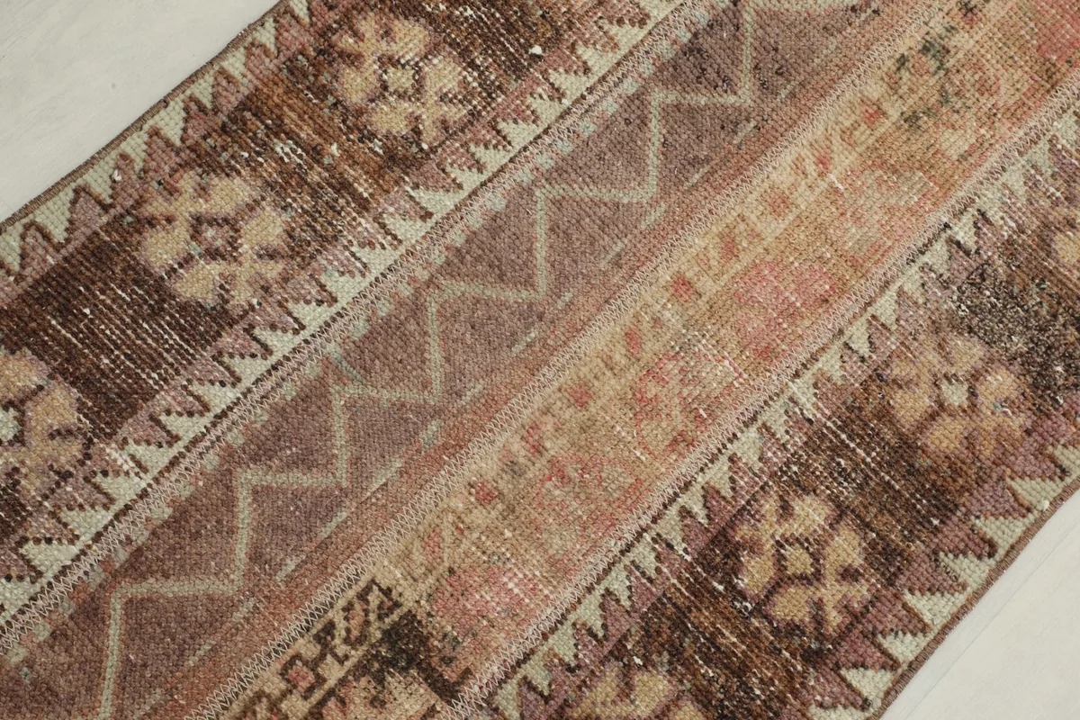Angled close-up showing the distinct striped patterns and colors of the rug