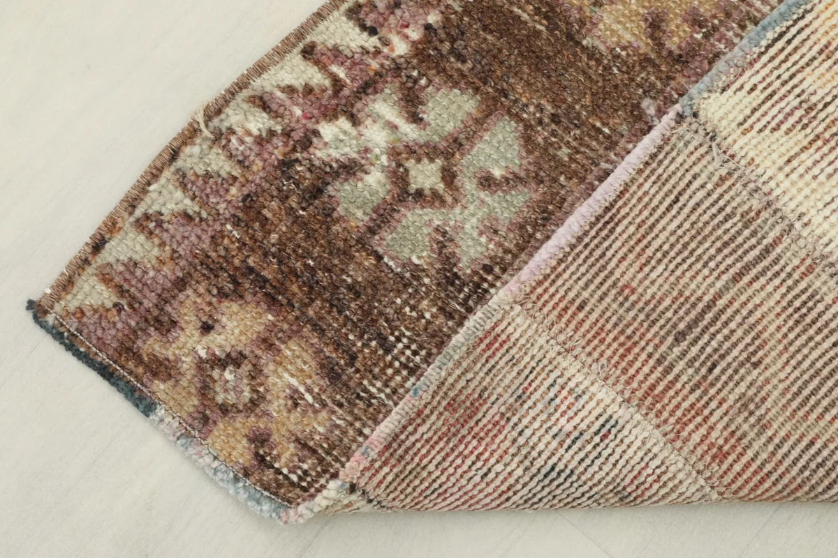 View of the underside of the rug, showing the cotton foundation and knotting