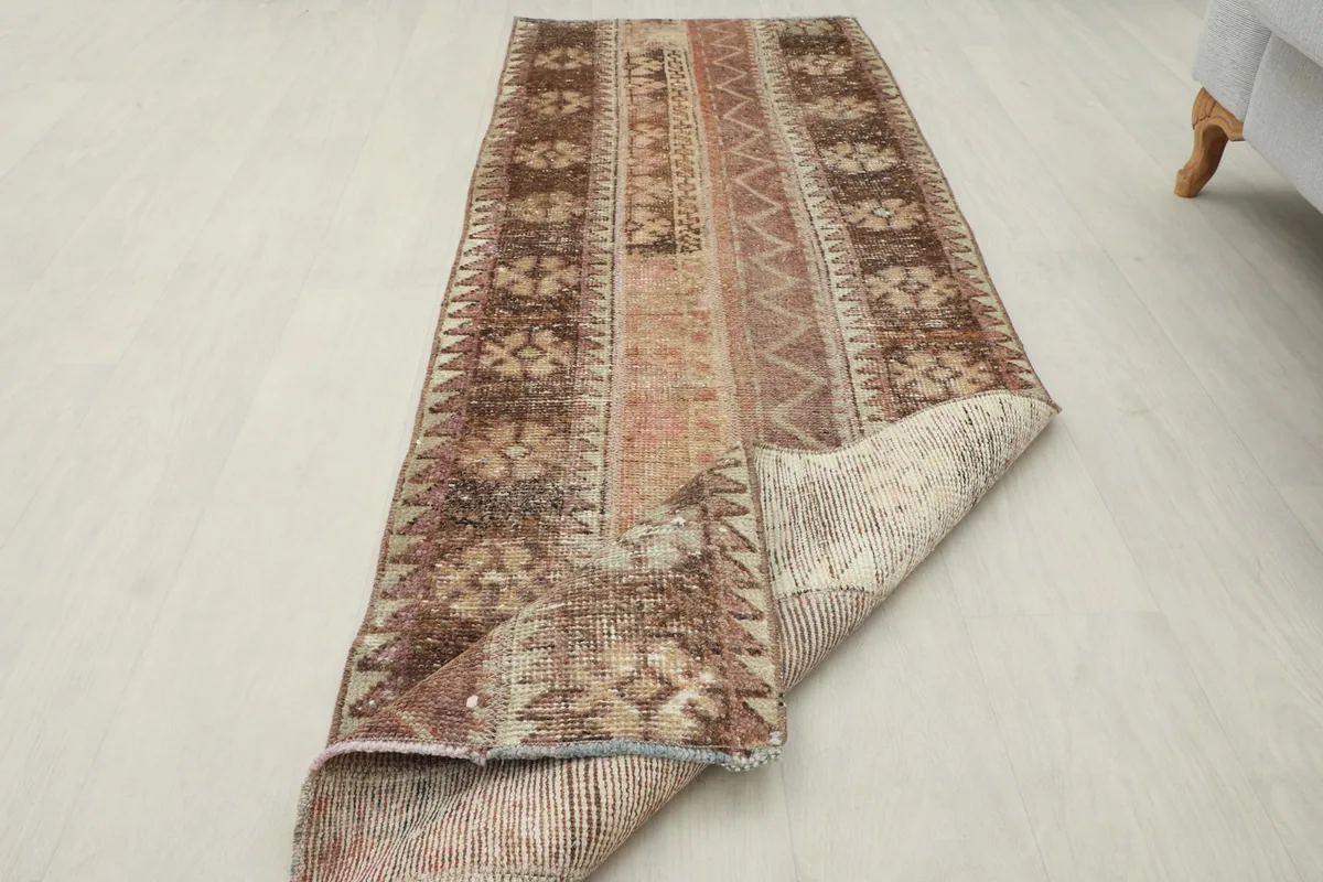 The rug partially folded to show its flexibility and thickness